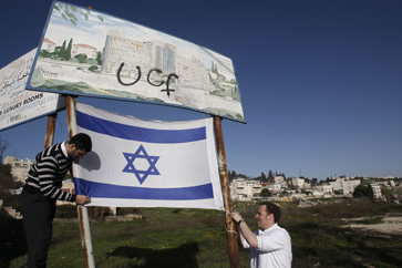 Right-wing Israeli activists place an Israeli flag in support of Jewish settlement activity in the Sheikh Jarrah neighbourhood