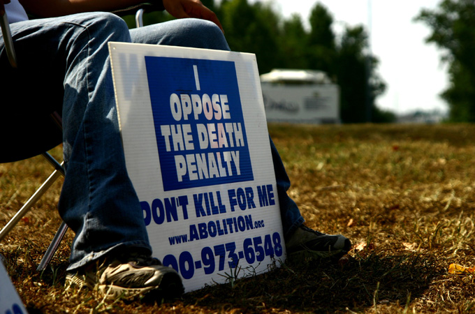 An activist against the death penalty displays his sign outside Greensville Correctional Center on September 23, 2010, in Jarratt, Virginia