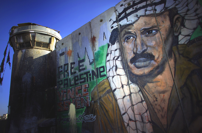 A mural of late Palestinian leader Yasser Arafat on the Israeli separation barrier at the Qalandiya checkpoint on August 24, 2011, in Ramallah