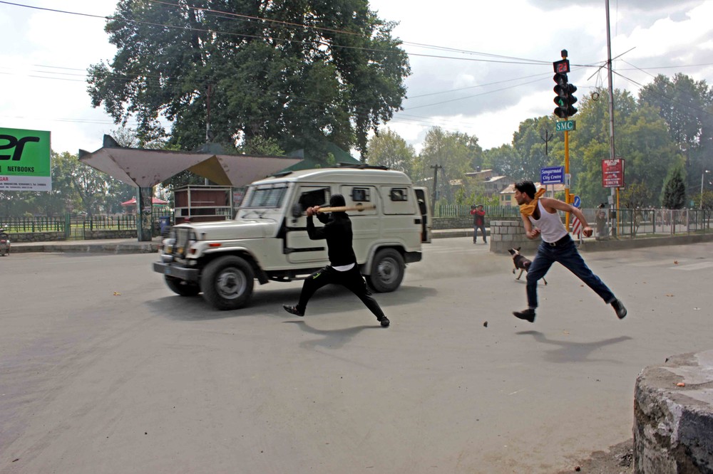 Angry protesters threw stones at a police vehicle in Srinagar, the capital of Jammu and Kashmir, during a protest over the anti-Islamic film "The Innocence of Muslims" on September 18, 2012.