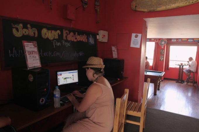 A tourist is seen looking at the Facebook website at a backpacker hostel in Lima