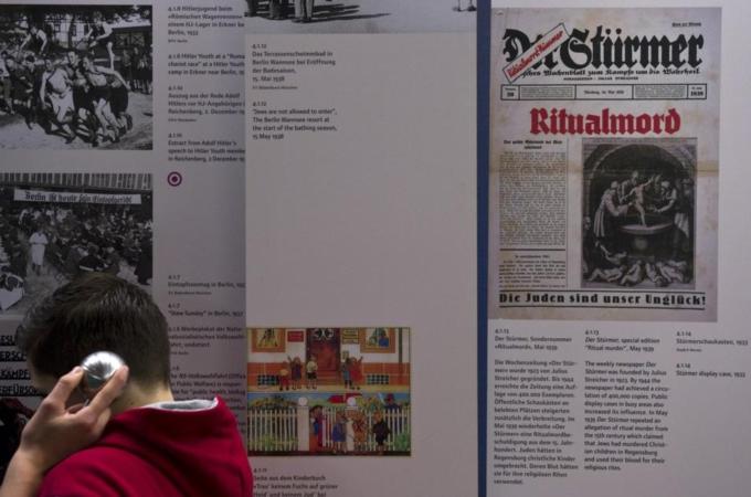 Young visitors listen to a recording nex