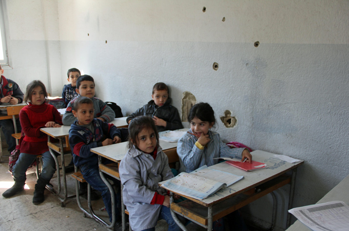 Classroom walls in the Bab el-Tebbeneh Middle School are riddled with bullet holes [Andreane Williams/Al Jazeera]