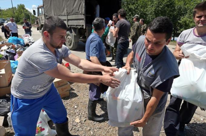 In Bosnia, thousands have volunteered time and resources to help those affected by the floods [EPA]