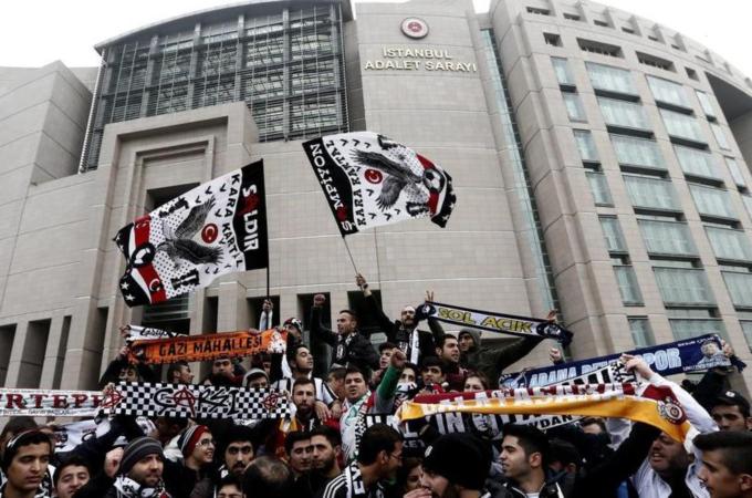 Turkish soccer club Besiktas' fan group 'Carsi' members gather in front of a courthouse to protest against the trial of 35 'Carsi' fans who took part in mass anti-government protests in 2013 [EPA]
