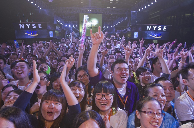 Alibaba employees celebrate as the first trading of shares begins on the New York Stock Exchange [EPA]