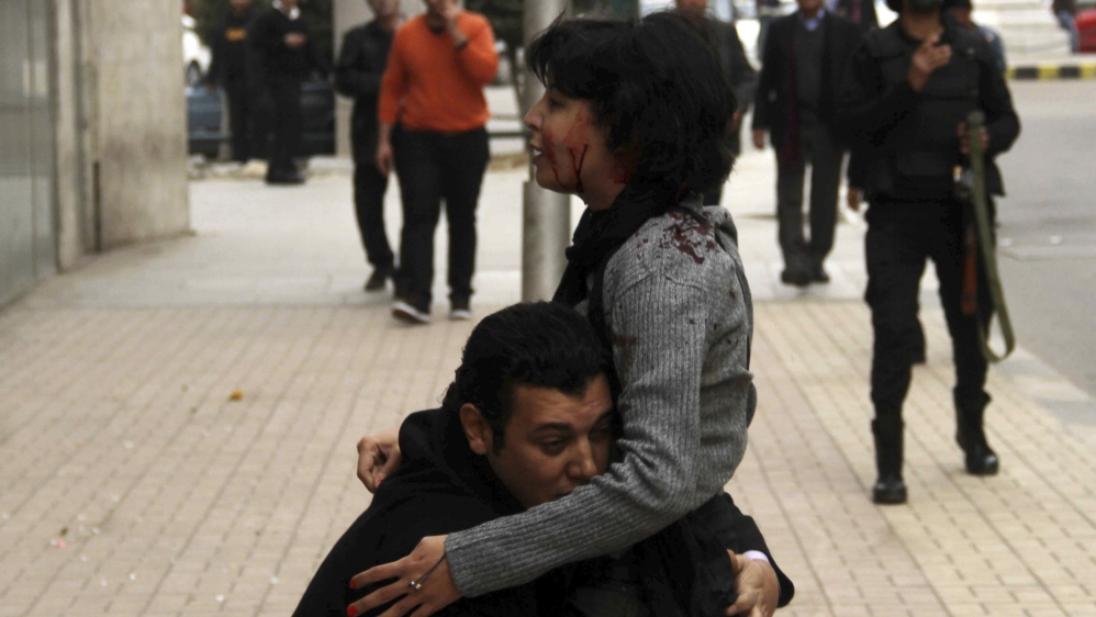 SPAP activist Sabbagh receives help after she was shot during a protest by the party in Cairo