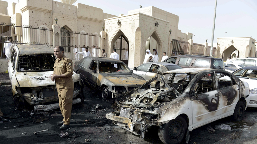 Policeman carries out an inspection after a car exploded near the Shi''ite al-Anoud mosque mosque in Saudi Arabia''s Dammam