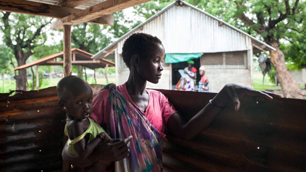 A woman and her malnourished child wait to receive treatment at the Leer Hospital, South Sudan [Getty]