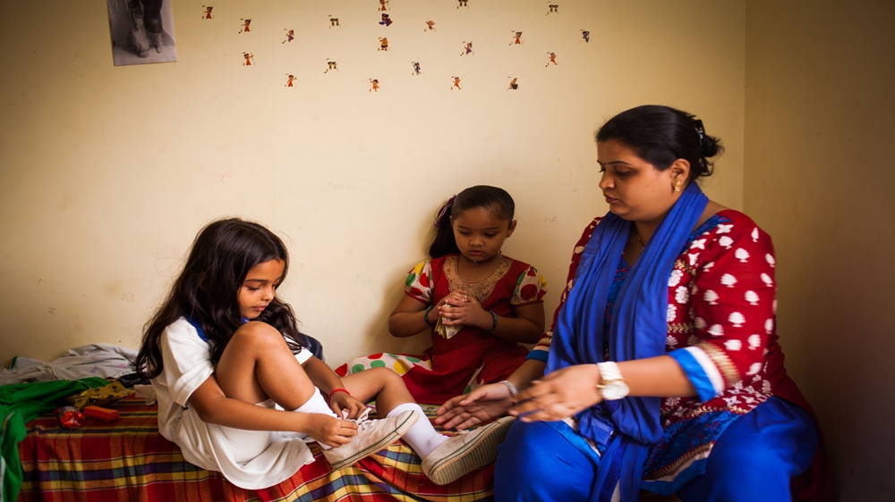 Spandan Chaturvedi's mother helps her put on her shoes as she gets ready in the dressing room. Her six-year-old co-star, Tasheen Shah, looks on [Karen Dias]