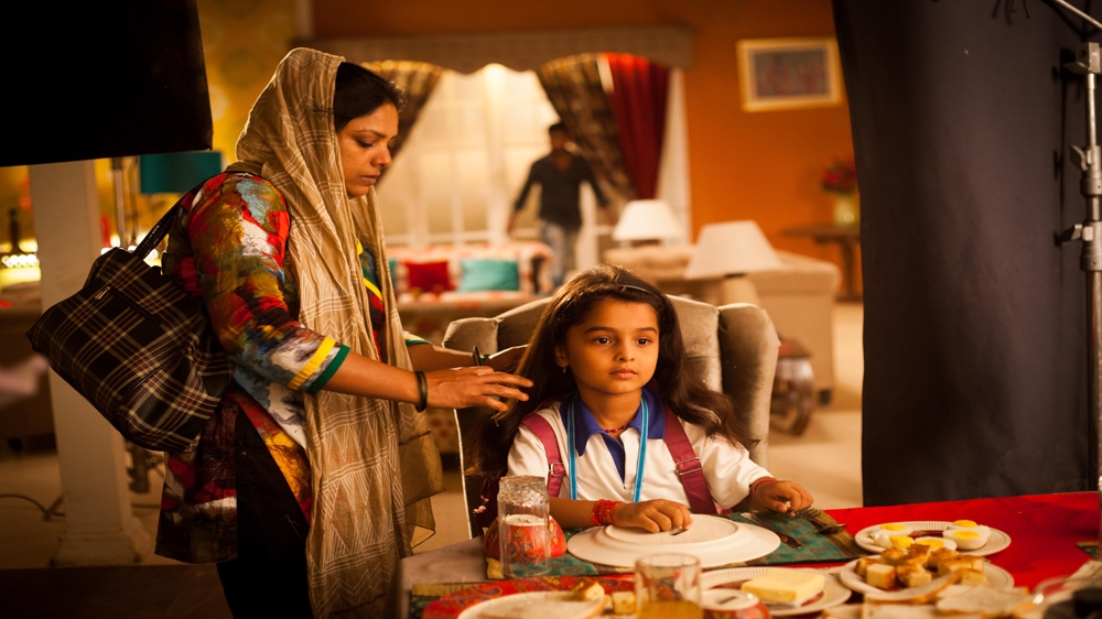 Six-year-old Spandan Chaturvedi gets her hair done by a make-up artist. She plays the lead role in the TV show Udaan , in which she portrays a bonded labourer [Karen Dias]