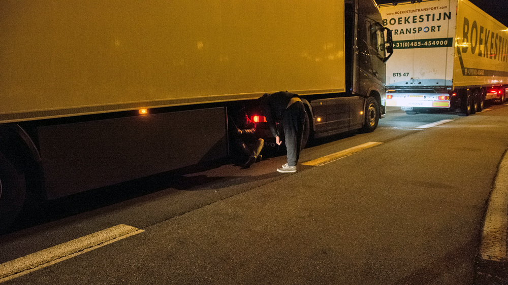 Clinging underneath lorries is one of the most dangerous ways the migrants attempt to slip past border officials [Ben Gerdziunas/Al Jazeera]