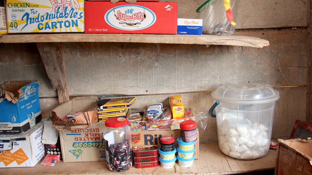 Adamou's kiosk has not been as well stocked since he was burgled two months ago [Femke van Zeijl/Al Jazeera]