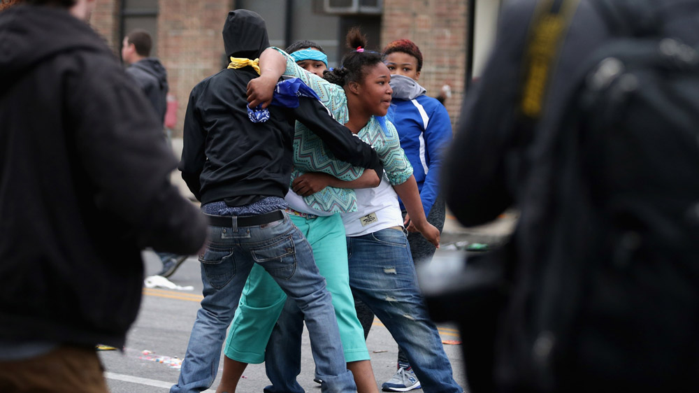 A woman screams “kill me” at the Baltimore police during protests at the corner of Pennsylvania and North Avenues following the funeral of Freddie Gray on April 27, 2015 in Baltimore, Maryland