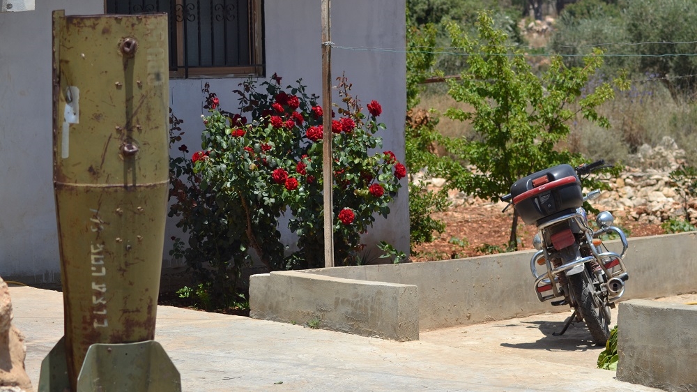 In defiance of the Israeli aggression, some residents of Zibqin have turned the casings of cluster bombs into garden ornaments [Joseph Ataman/Al Jazeera]