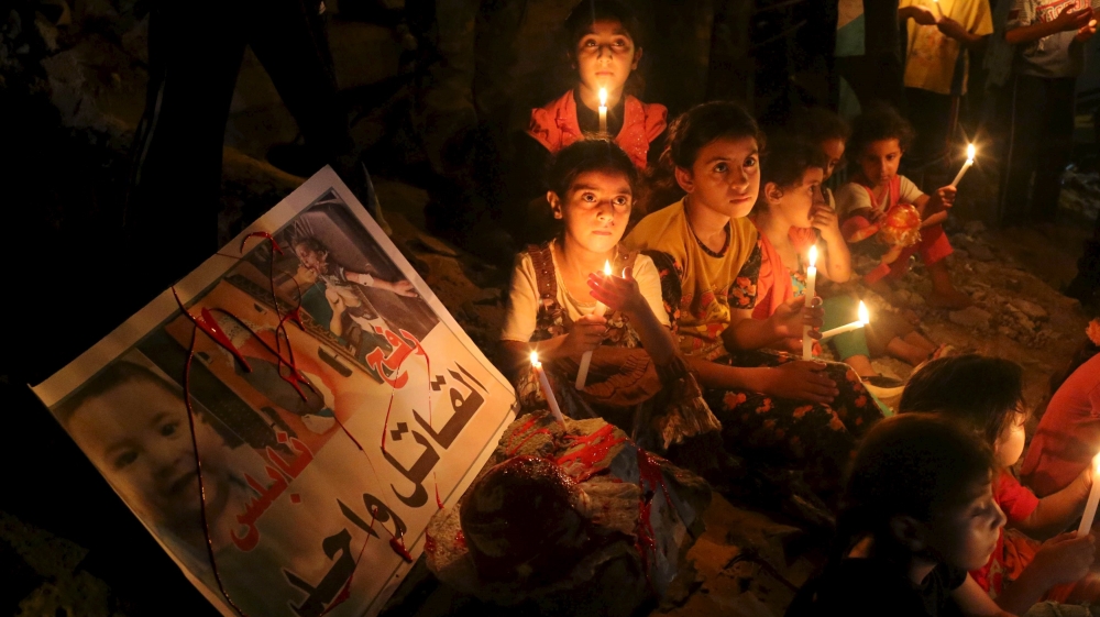 Palestinian children light candles during a rally to remember 18-month-old Palestinian baby Ali Dawabsheh who was killed after his family''s house was set on fire in a suspected attack by Jewish extrem