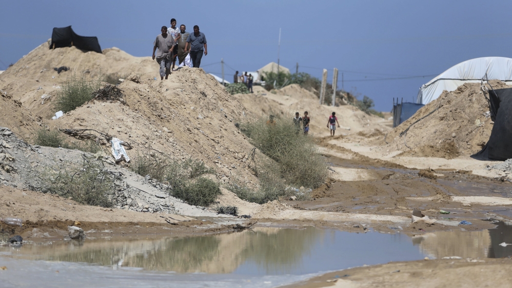 Palestinians inspect the damage beneath the Gaza-Egypt border, in Rafah in the southern Gaza Strip