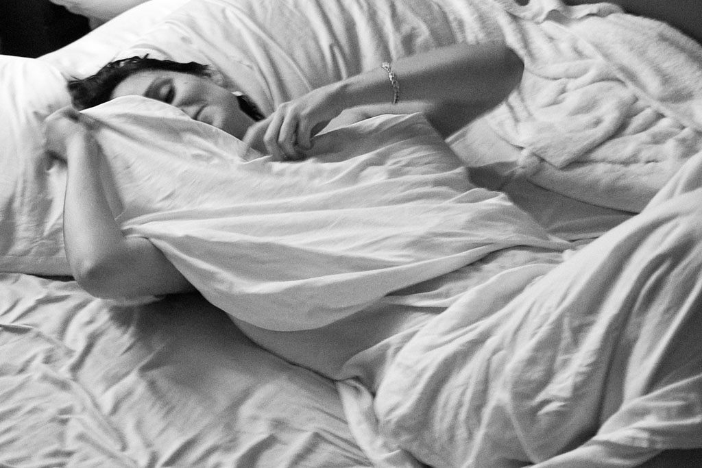  Jennifer relaxes in the bed of her Manhattan apartment while I was visiting from Cleveland, Ohio. [Angelo Merendino/Al Jazeera] 