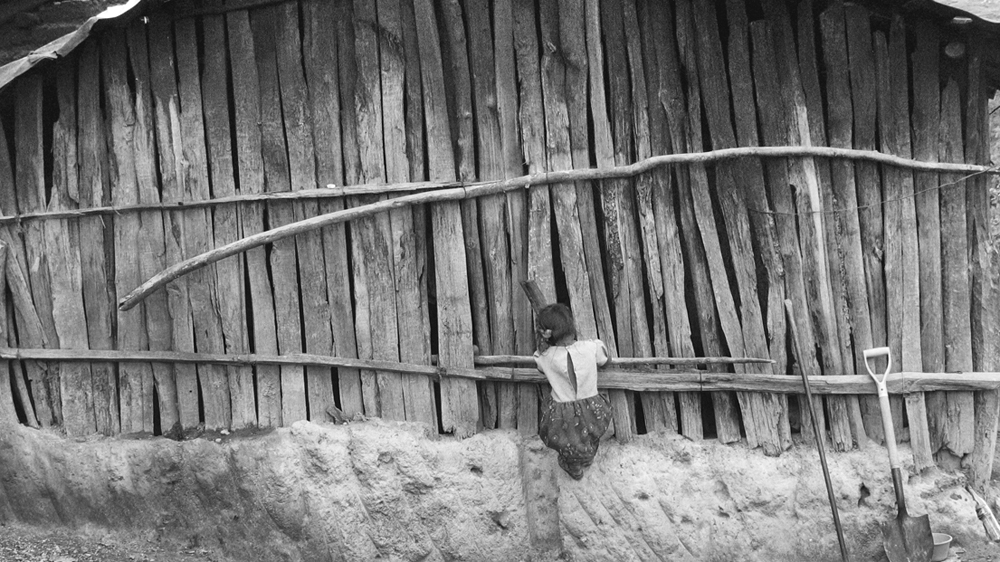 A girl peeks into the kitchen of Maurilia's home [Prometeo Lucero]