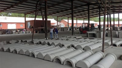 Western-style columns made of glass fibre lie on the floor in a local manufacturing company in Qiqihar [Raphael Balenieri/Al Jazeera]