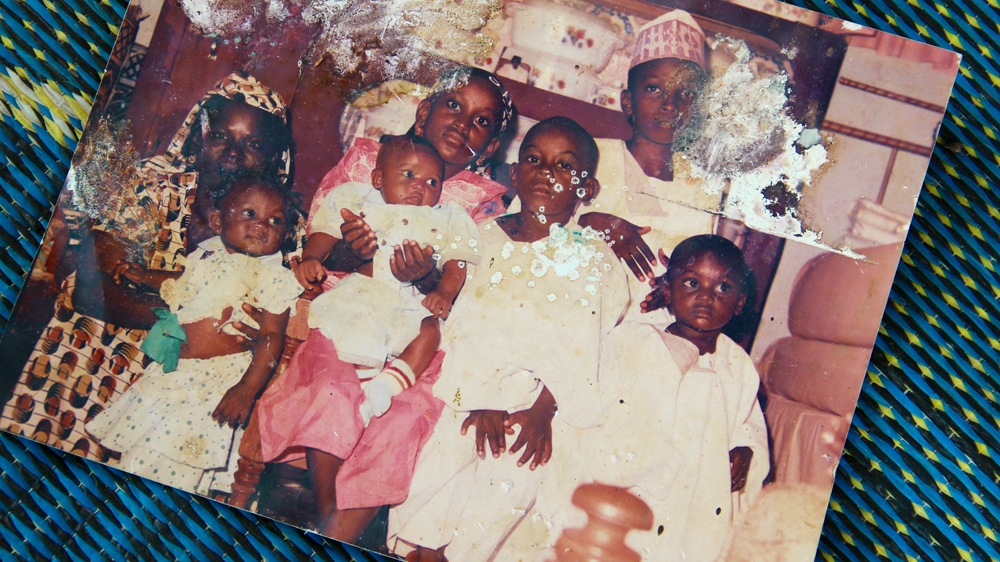 A family picture taken about 20 years ago. Aliyu Mohammed is the third boy on the right, his mother is on the far left and his brother Abubakar is on the far right [Femke van Zeijl/Al Jazeera]