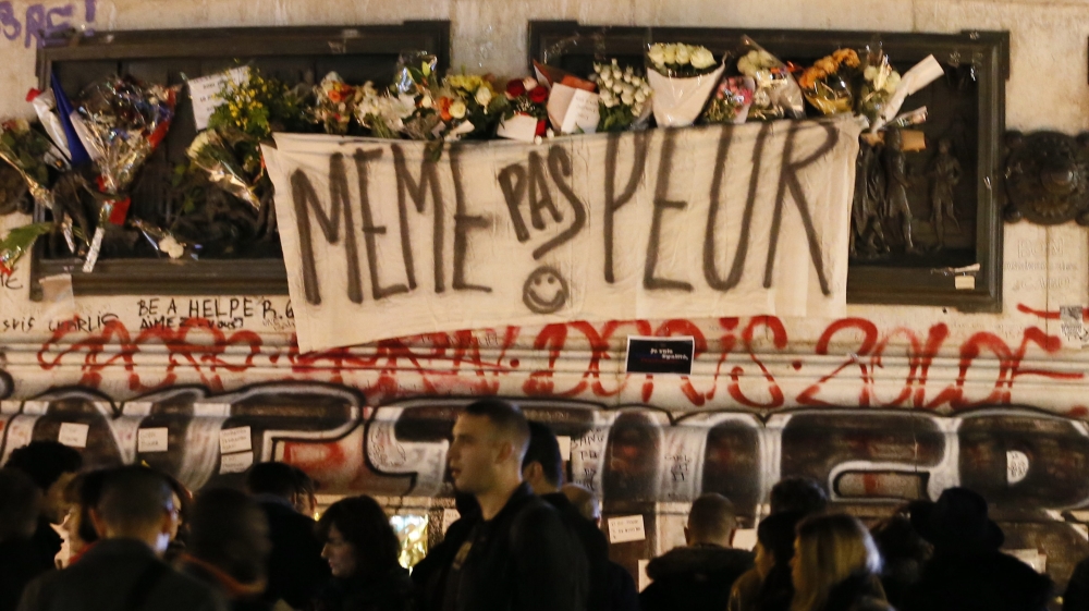 A sign reads ''Not even afraid'', draped on the statue on Place de la Republique in Paris, France [EPA]