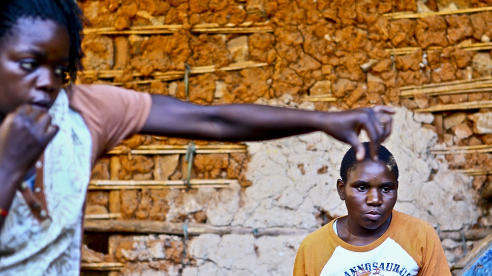 Hellen Baleke, left, and Lydia Nantale practise their jabs [Edward Echwalu/Al Jazeera] 