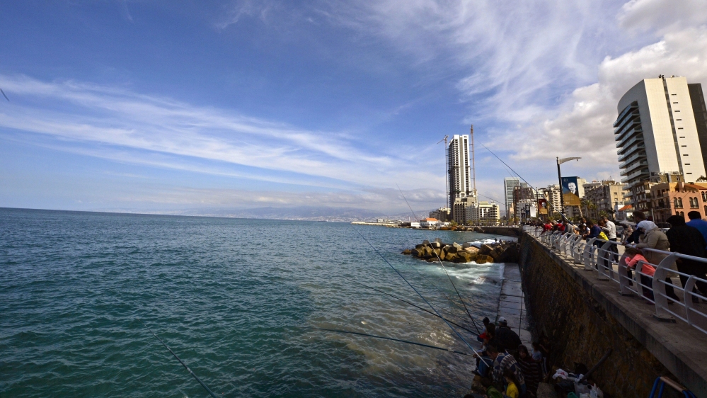 People fish at the coastline of al-Manara during a sunny day in Beirut, Lebanon [EPA}