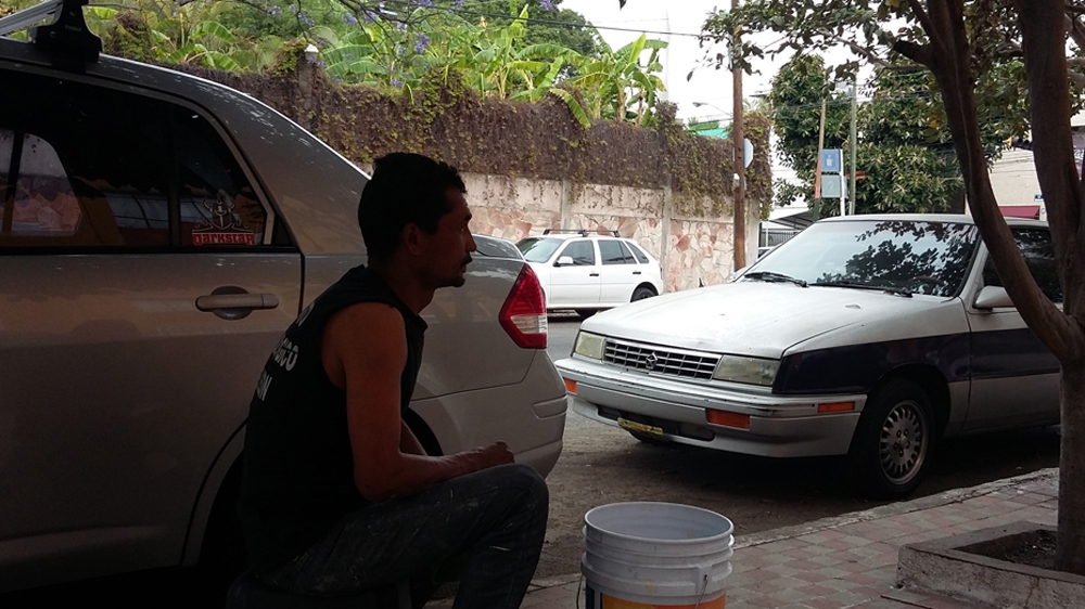 A franelero can make up to 600 pesos (about $35) on a good day, but on another he might make only 50 pesos ($3) [Duncan Tucker/Al Jazeera] 