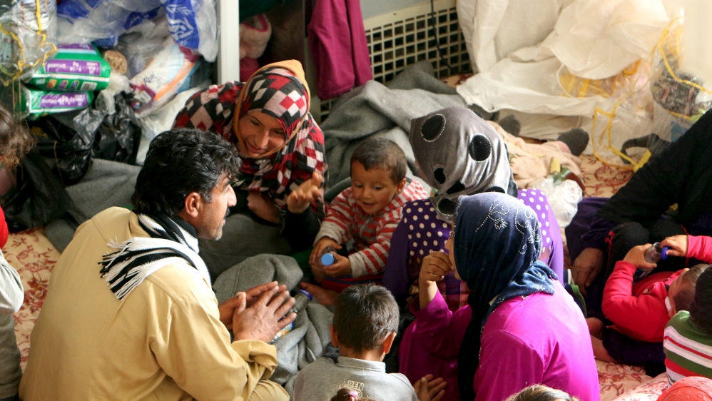 People, displaced by violence from Islamic State militants, gather in a building that is used as a temporary shelter in Makhmour