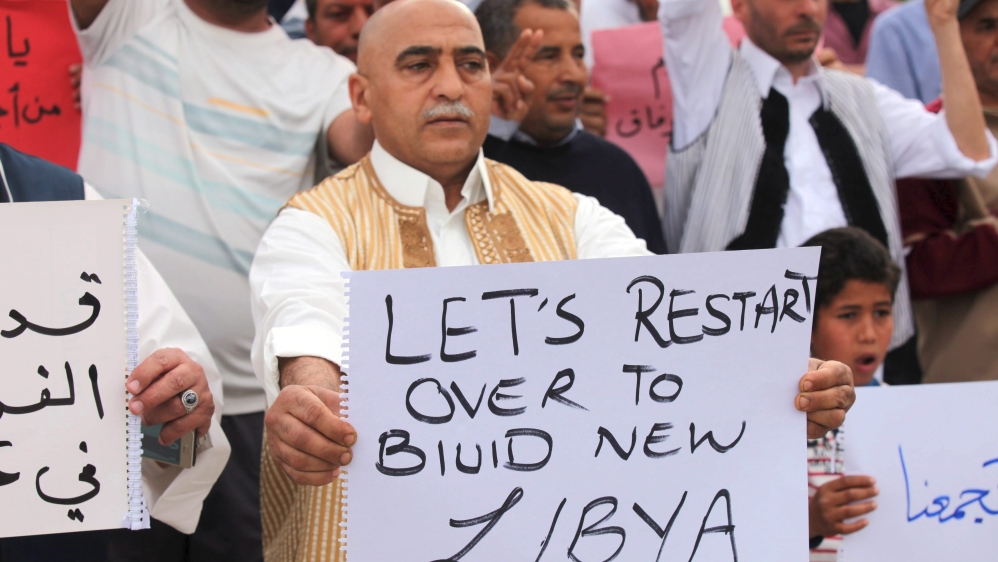 Supporters of Libya''s unity government hold signs during a demonstration in Tripoli
