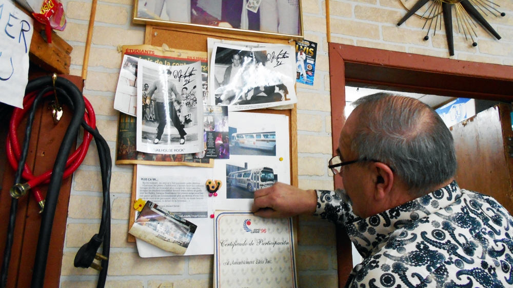 The walls of Ameublement Elvis are plastered with photos of Elvis Presley and old newspaper clippings about the store [Andreanne Williams/Al Jazeera]