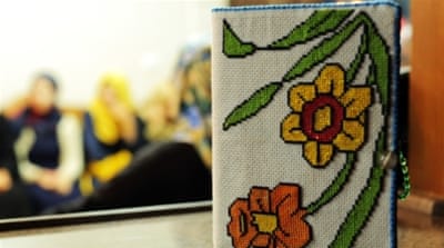 D embroidered a book for her mother while in prison [ Abed al Qaisi/ Al Jazeera]