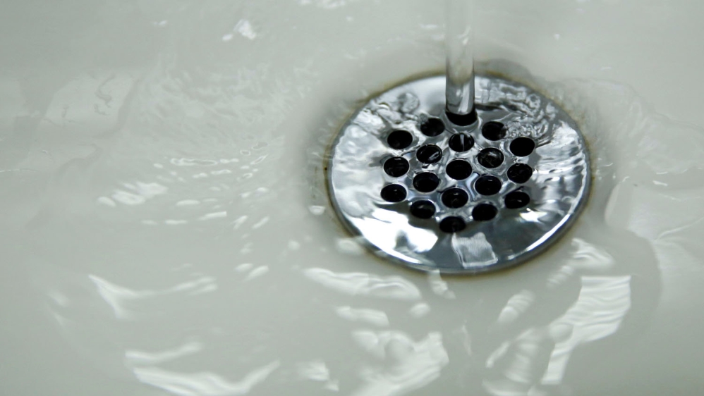 Running tap water is seen in Flint, a city struggling with the effects of lead-poisoned drinking water [Carlos Barria/Reuters]