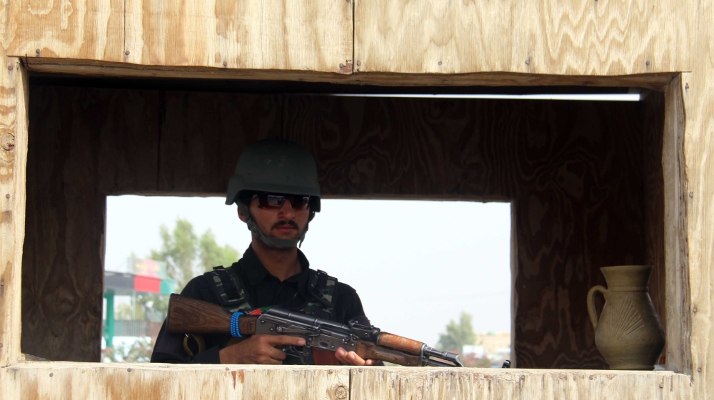 Afghan security officials stands guard at a roadside check point, after security has been intensified following the killing of Taliban leader Mullah Akhtar Mansoor [EPA]