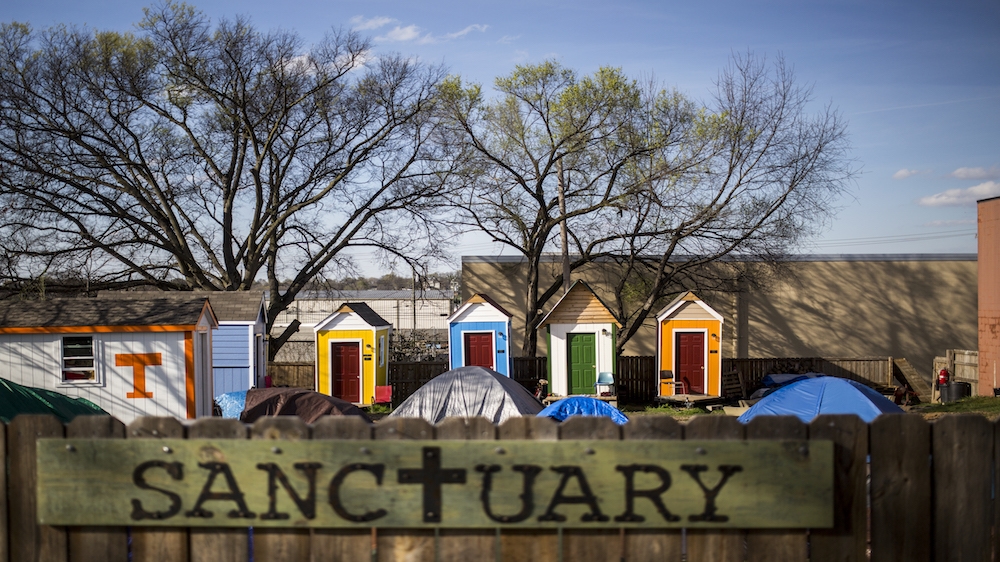 Tiny houses line the back of The Sanctuary homeless community in the backyard of the Green Street Church in Nashville [Joe Buglewicz/Al Jazeera] 