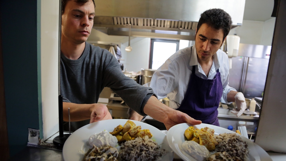 For Moayyad Hamoud cooking is both a means of survival and a way of sharing his culture and a part of himself [Micah Garen/Al Jazeera]