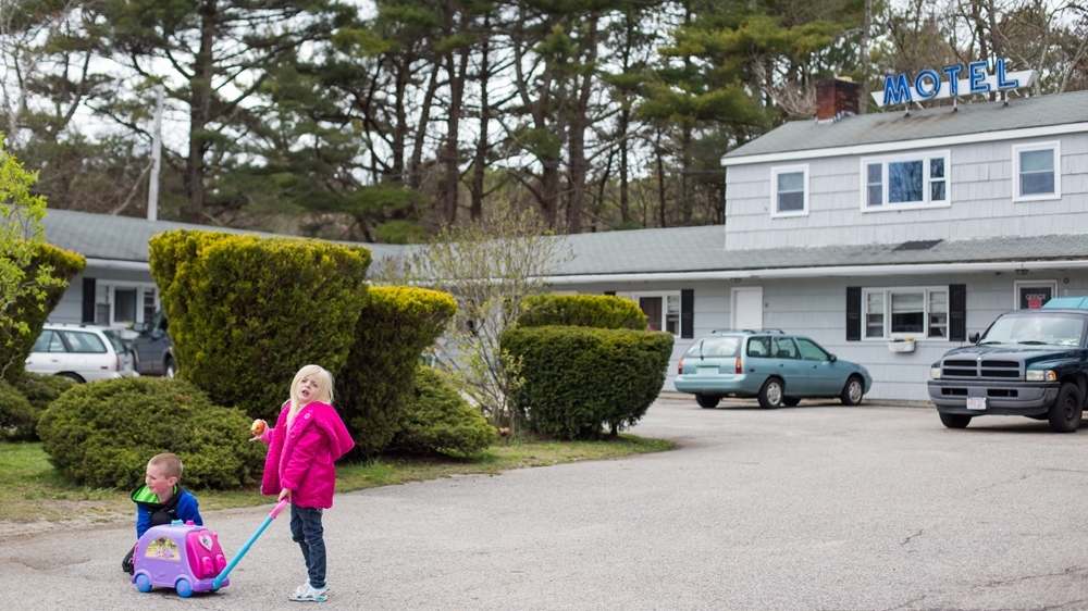  Sofiya and Colby play in the motel parking lot [Carolyn Bick/Al Jazeera] 