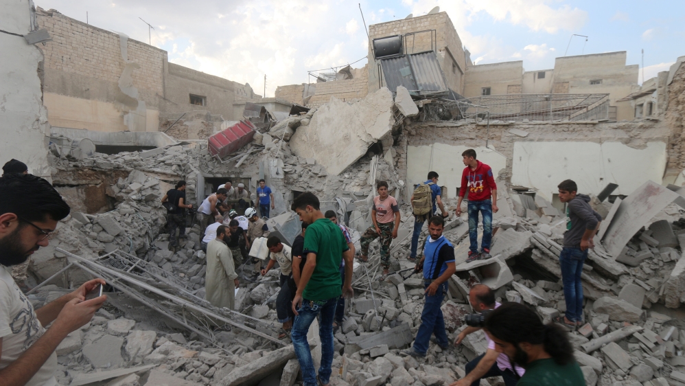 Men look for survivors under the rubble of a damaged building after an airstrike on Aleppo''s rebel held Kadi Askar area