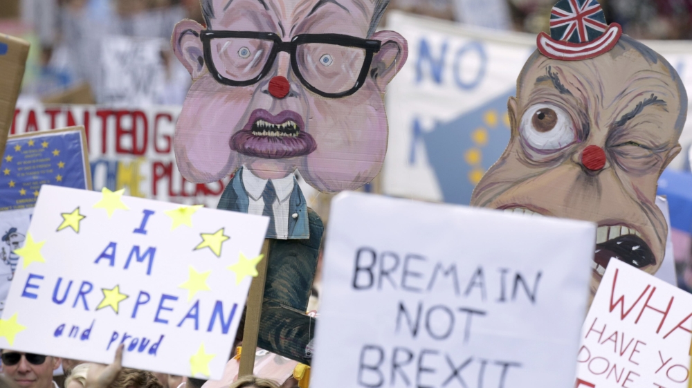 People hold banners, depicting Michael Gove and Nigel Farage, during a ''March for Europe'' demonstration against Britain''s decision to leave the European Union, in central London, Britain [REUTERS]