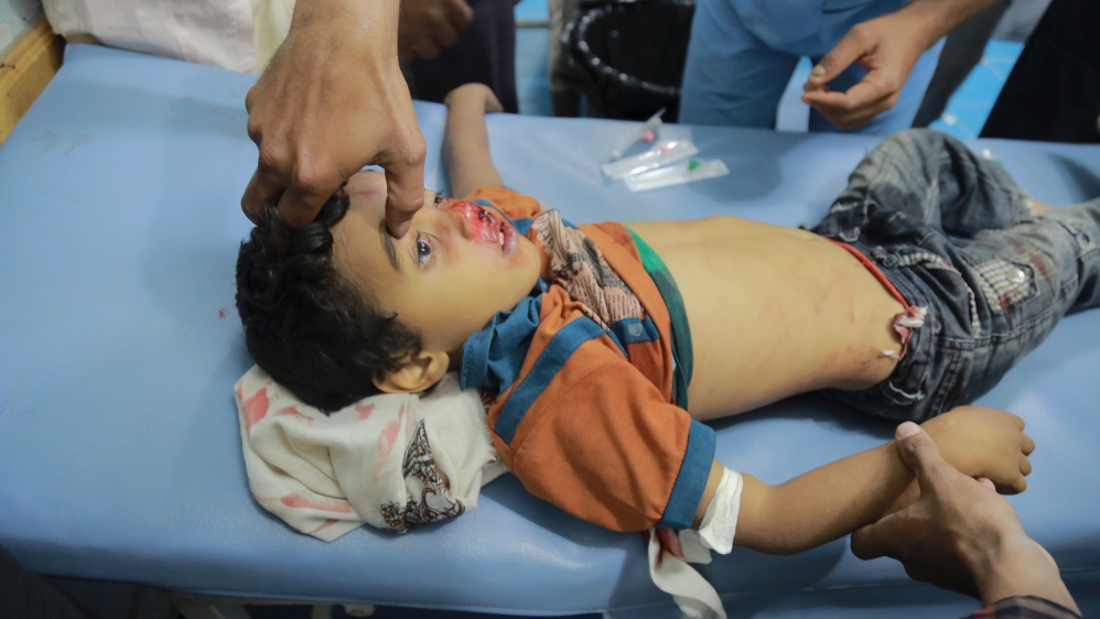 A medic attends to a boy injured by Houthi shelling in Yemen''s southwestern war-torn city of Taiz