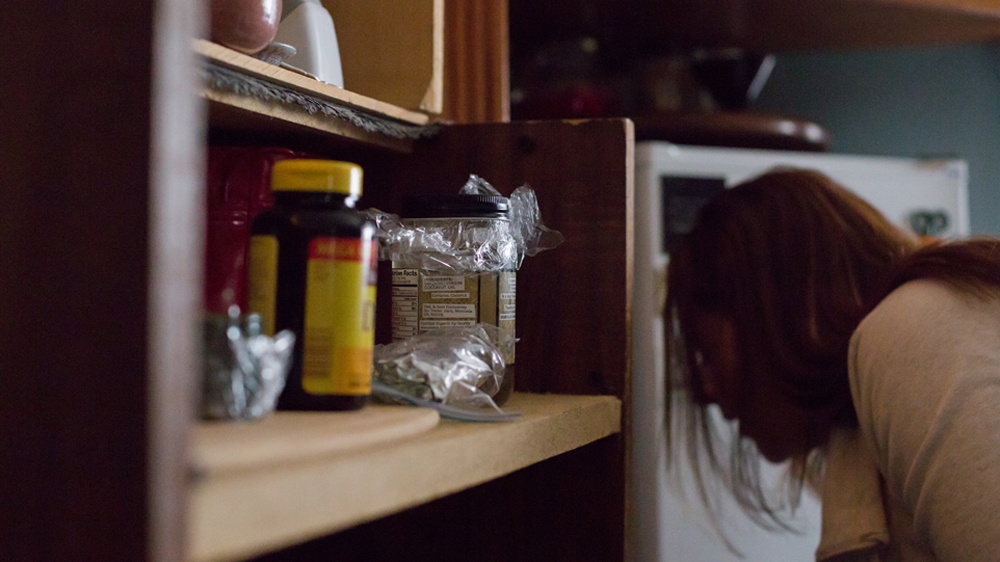  Becca's shelves are full of holistic herbal remedies meant to help her mental and physical wellbeing [Carolyn Bick/Al Jazeera] 