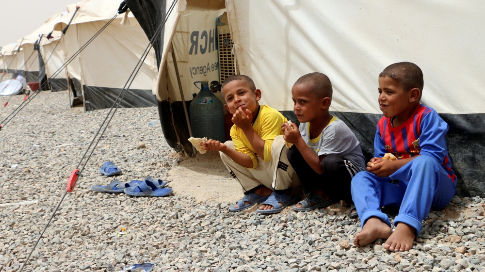 Displaced people, who fled from clashes between Islamic State militants and Iraqi security forces in Mosul, sit near a tent at the camp southeast of Mosul