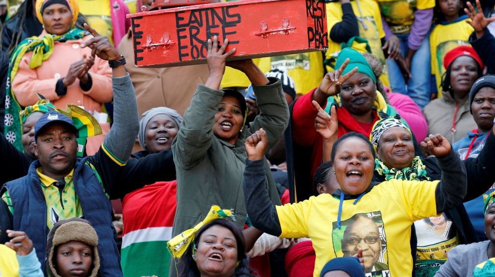 Supporters of the African National Congress (ANC) carry a mock coffin of the opposition South Africa''s Economic Freedom Fighters (EFF)