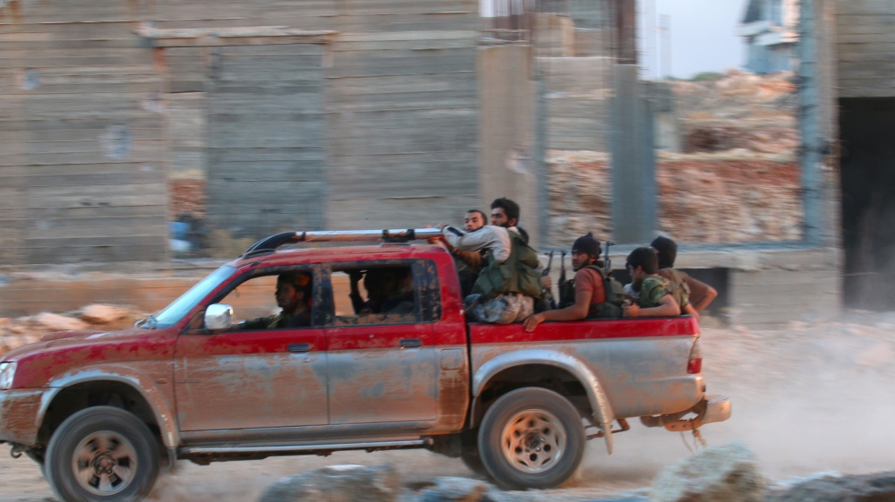 Fighters of the Syrian Islamist rebel group Jabhat Fateh al-Sham, the former al Qaeda-affiliated Nusra Front, ride on a pick-up truck in the 1070 Apartment Project area in southwestern Aleppo