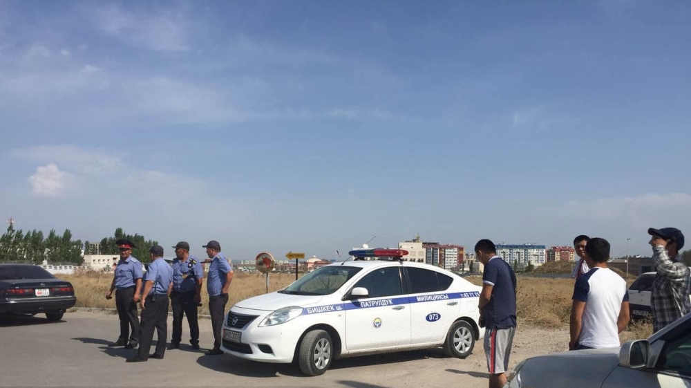 A police car is parked near the place of bombing, near Chinese embassy in Bishkek