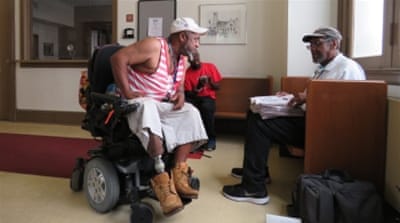 
Scott Lovell, left, says he is a convicted felon in three states and even though he can still vote - he says he won't. 'My vote ain't important,' he says [Jessica Sarhan/Al Jazeera] 