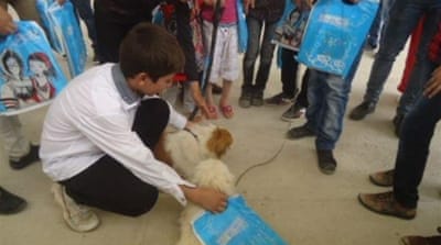 Organisers say that many children exhibit a sense of peace when they interact with the animals [Abdelazizz Ahmed/Al Jazeera]
