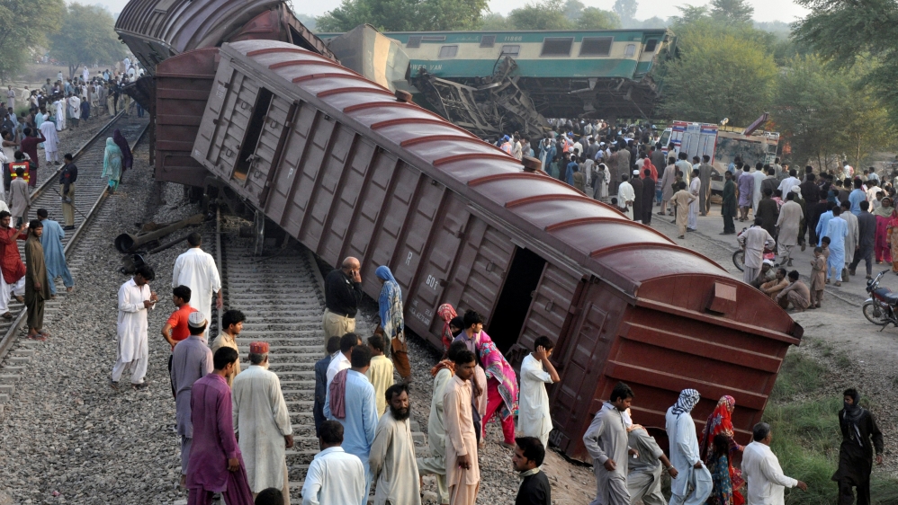 Locals gather at the scene where two trains collided near Multan