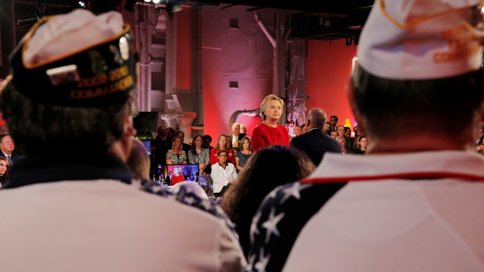 U.S. Democratic presidential candidate Hillary Clinton listens to a question at a presidential candidates "Commander-in-Chief" forum aboard the decommissioned aircraft carrier "Intrepid" in New York